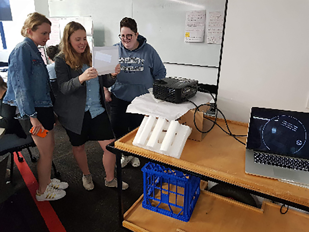 Image of the team testin the projection for the Orbuculum on a small piece of acrylic