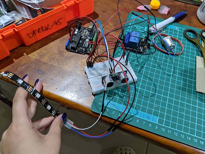 Circuit with Arduino Uno board, ultrasonic sensor and neopixel lightstrip