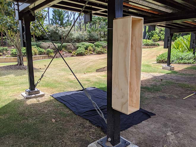 Windmill box mounted onto one of the bridge pillars using a threaded rod bent into a U shape.